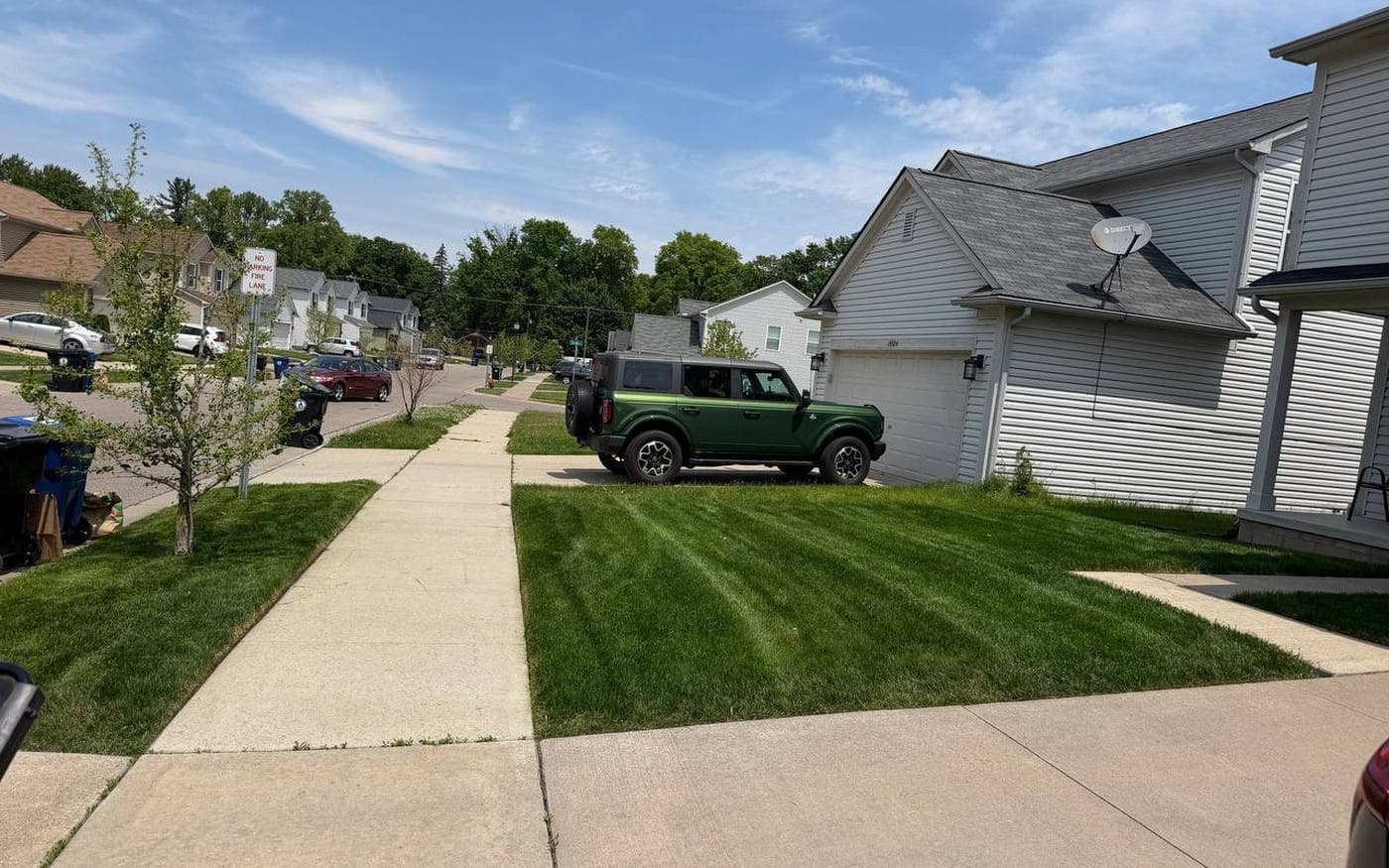 Woolfman Lawn Services truck parked on a job in metro Detroit